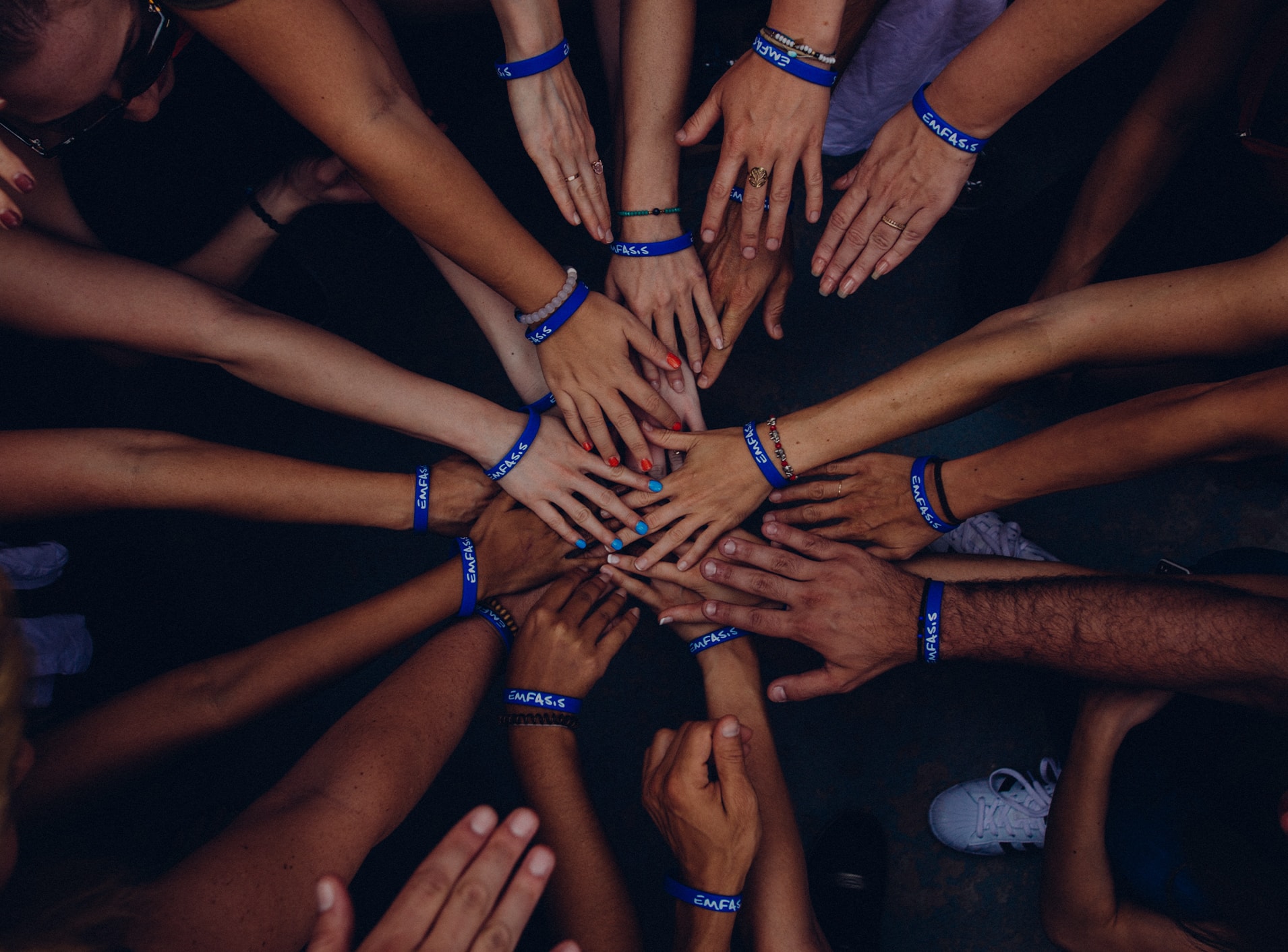 The featured image shows people putting their hands together in unity. Click to learn more about the Weyco culture and its community impact. 