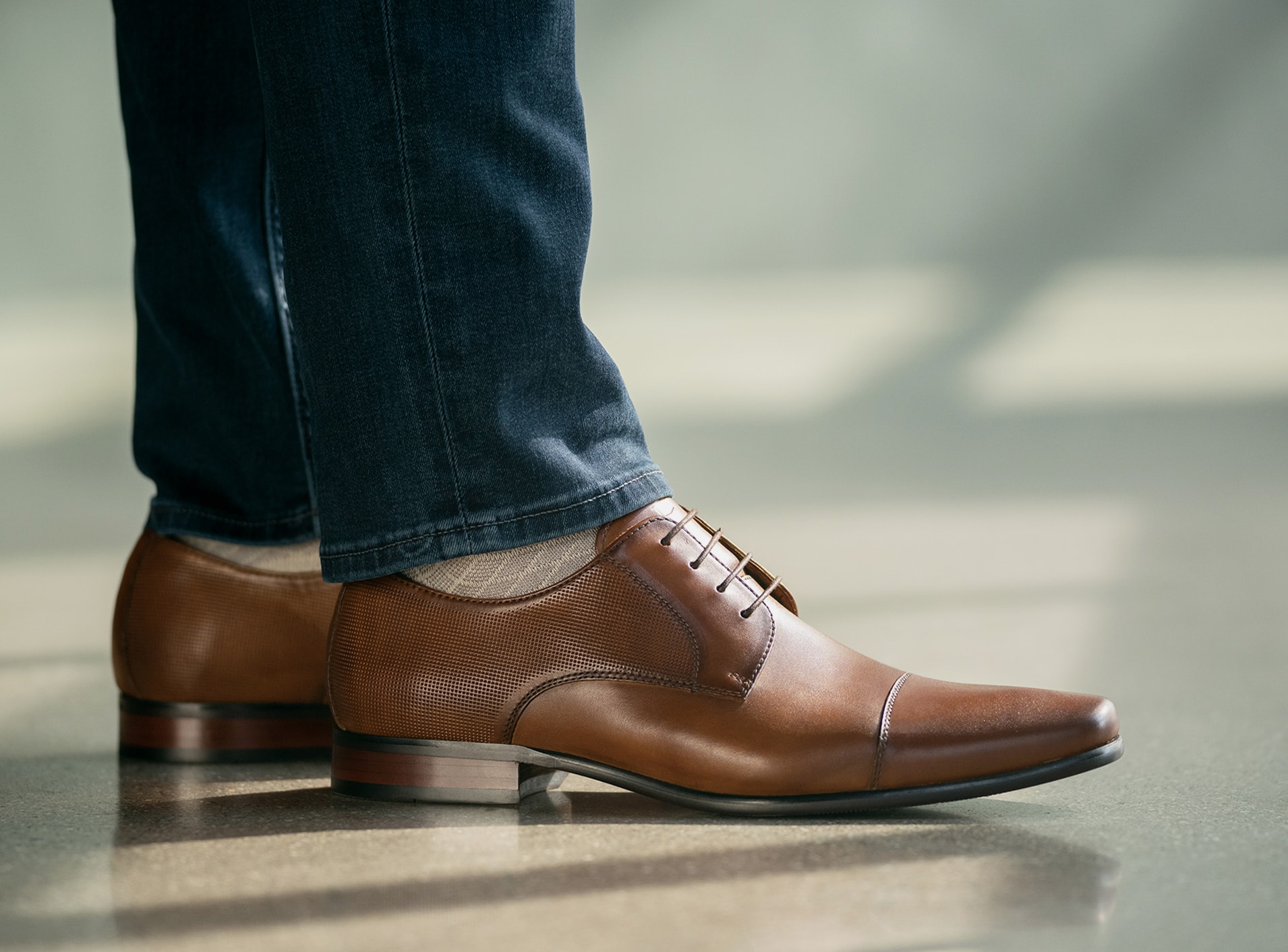 The featured shoe in this image is the Postino Cap Toe Oxford in Cognac. Click to learn more about each brand in the Weyco portfolio. 