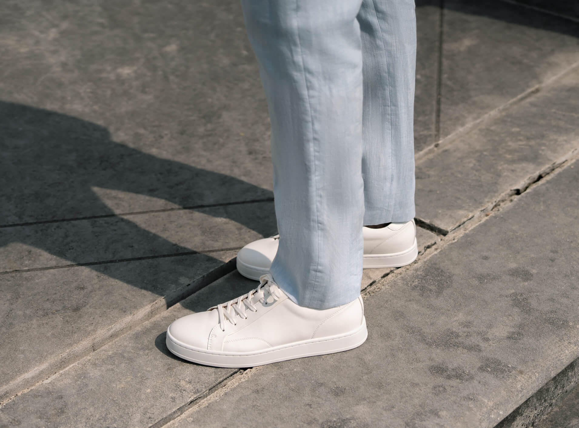 Image features the Florsheim Monopoli sneaker in white on a concrete floor.